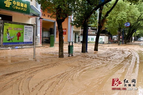 暴雨使县城街道洪水泛滥淤泥堆积