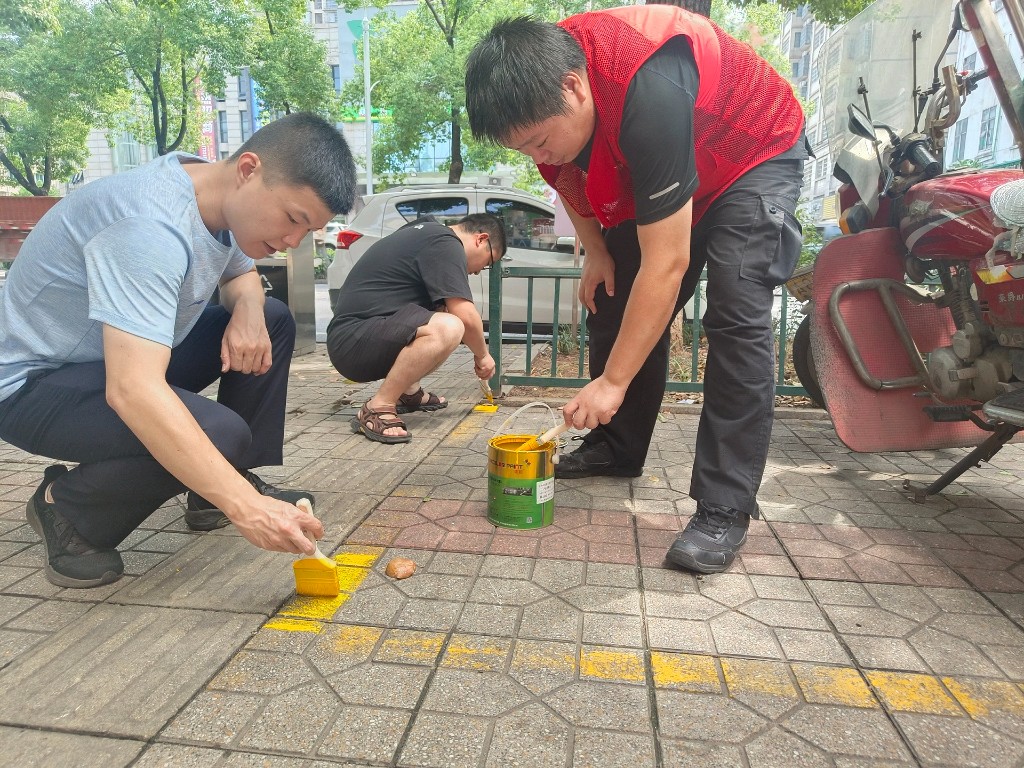 清水塘街道城管队员施(补)划车位,为非机动车“安家”、为城市提“颜值”